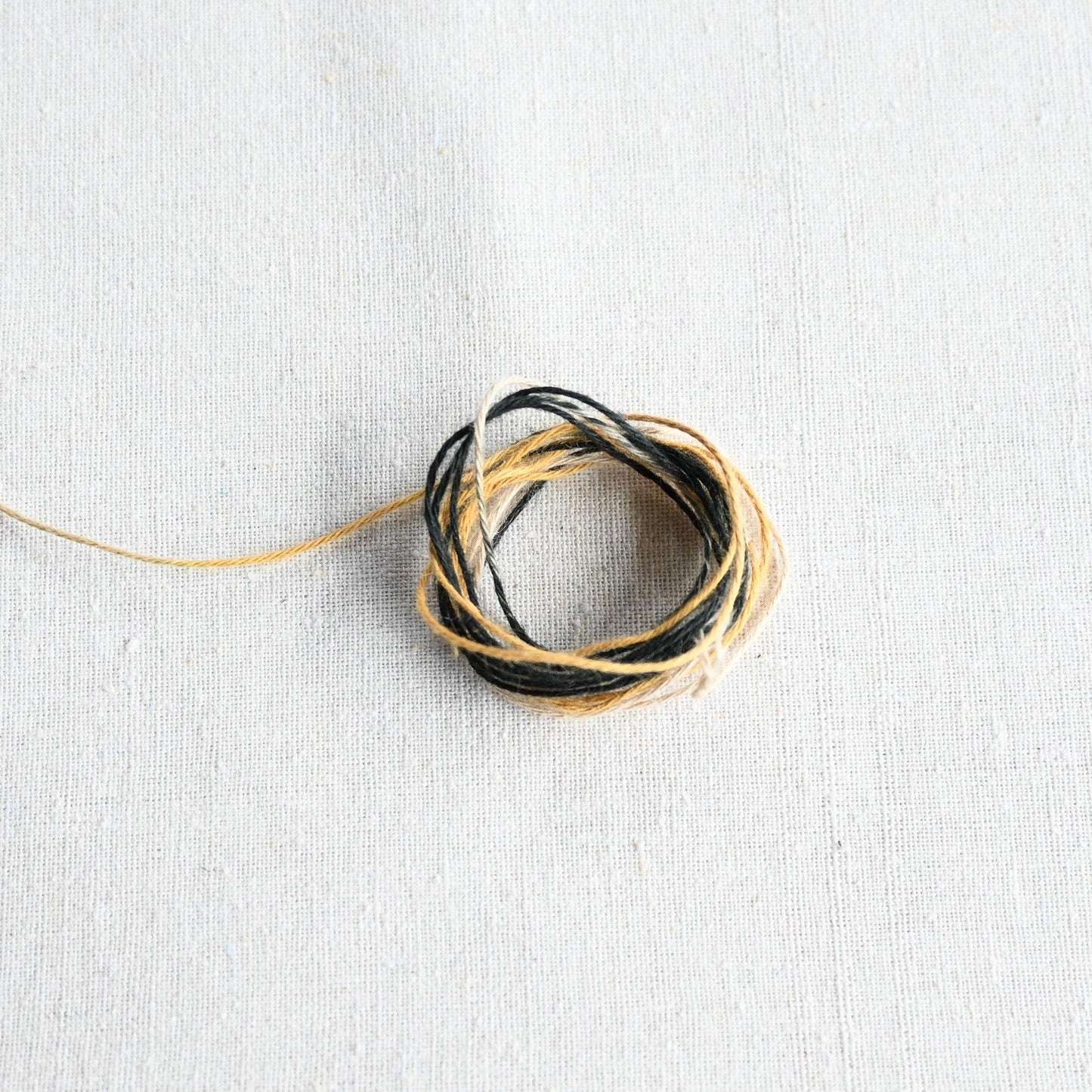 Authentic Japanese Hida sashiko threads in yellow gradation on calico cotton.