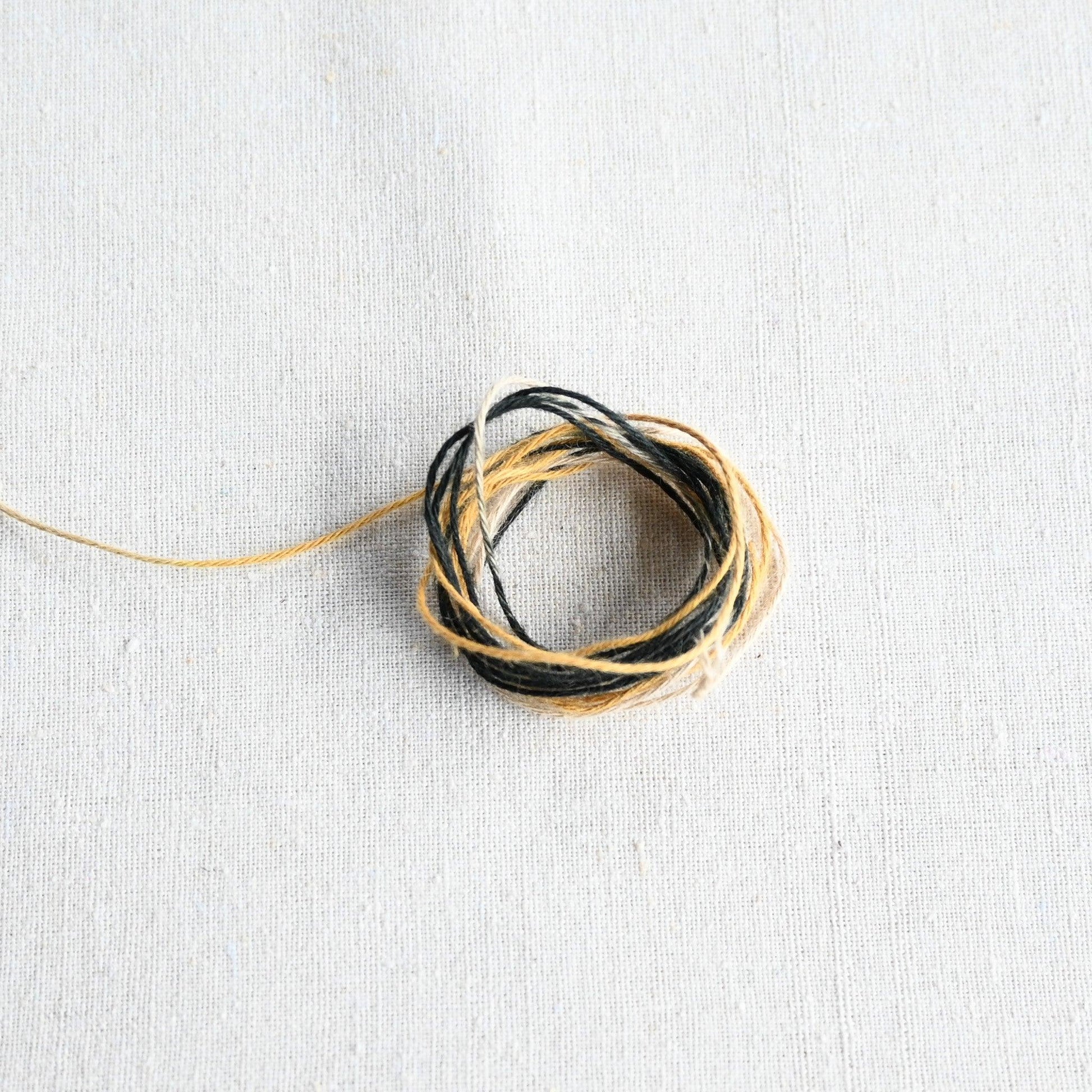 Authentic Japanese Hida sashiko threads in yellow gradation on calico cotton.