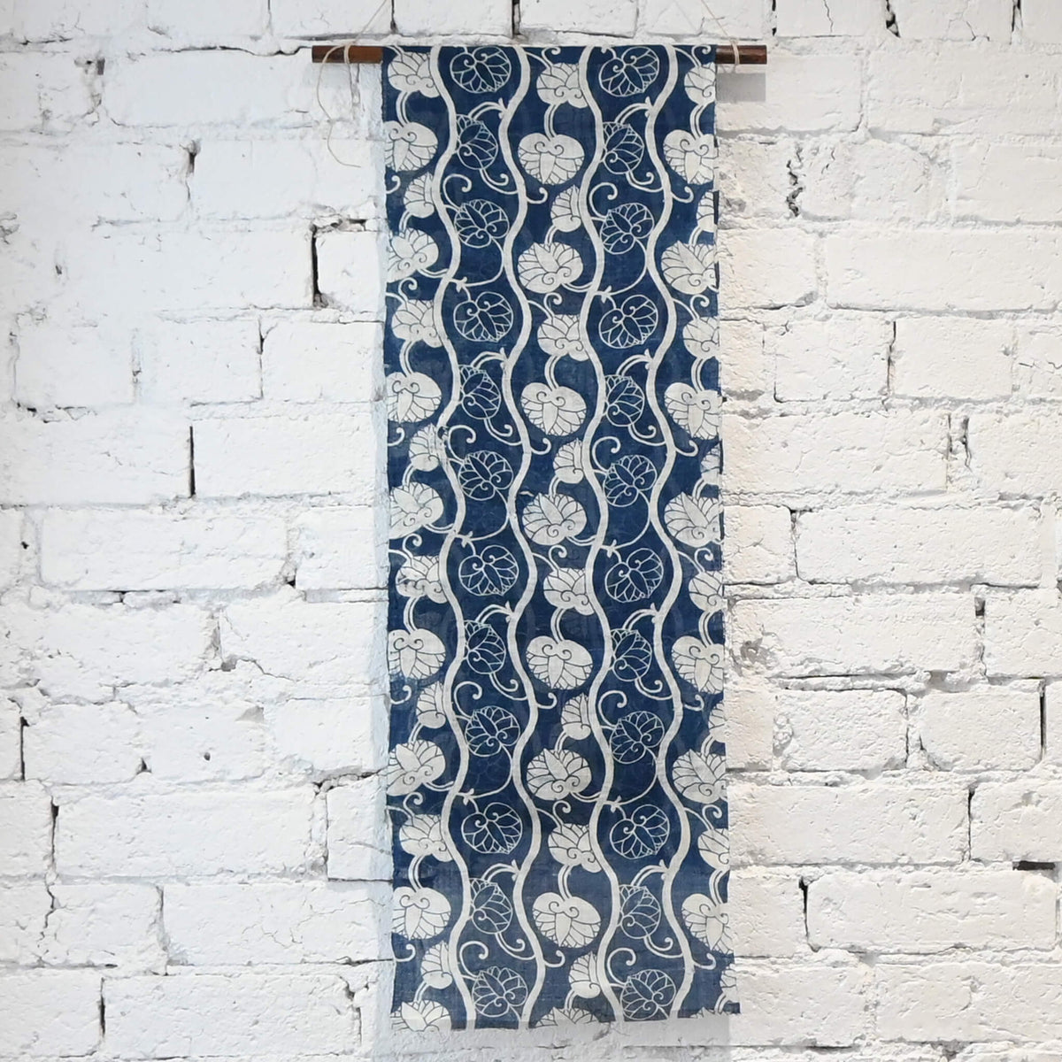 Hanging new of antique indigo katazome dyed hemp futon cover panel from the early 20th century, Aoi leaves with Yoroke stripes.