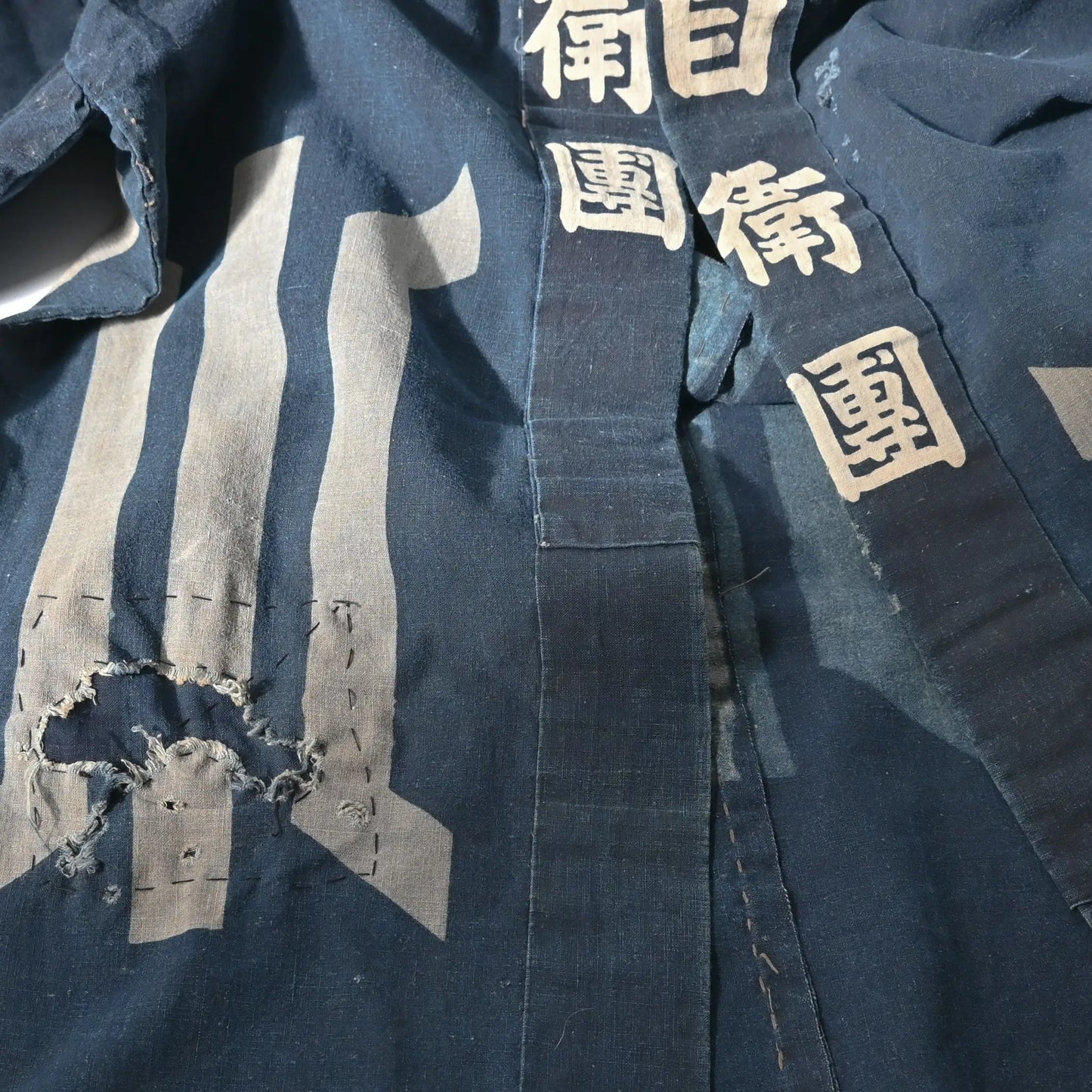 Detailed view of rare vintage indigo cotton hanten, belonged to a local rescue organization that assisted people during floods and fires.