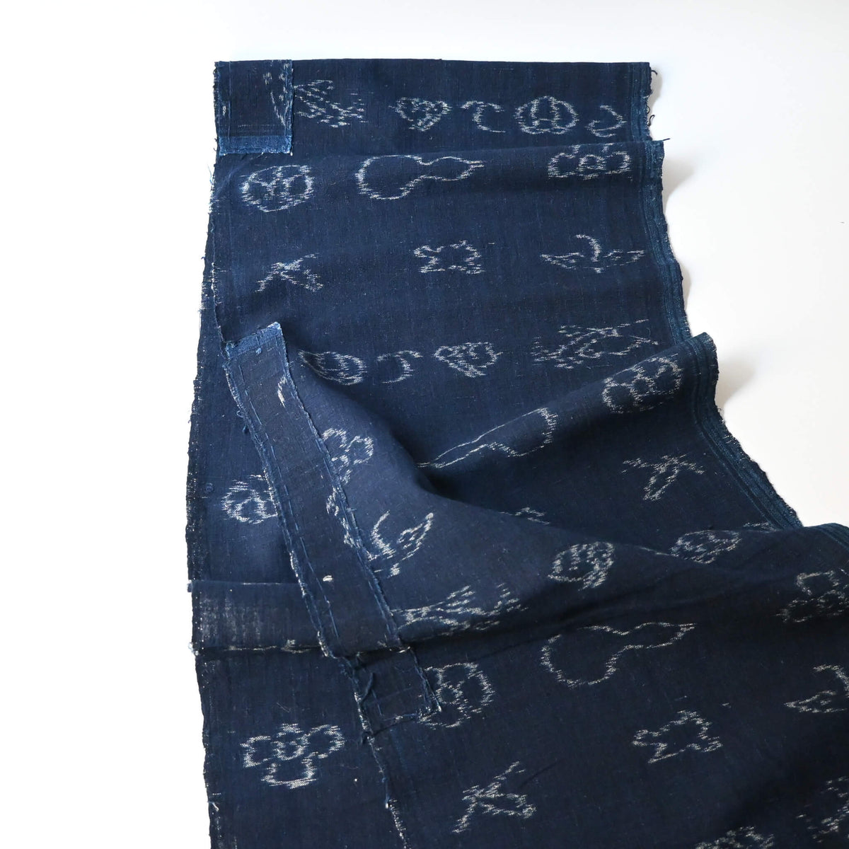 Full view of rare vintage indigo kasuri cotton with pictorial motifs,  including gourds, plum blossoms, and umbrellas.