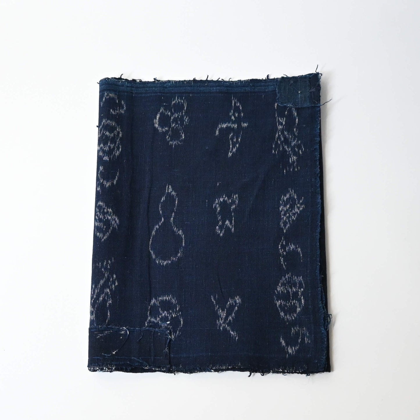 Rare vintage indigo kasuri cotton with pictorial motifs,  including gourds, plum blossoms, and umbrellas.