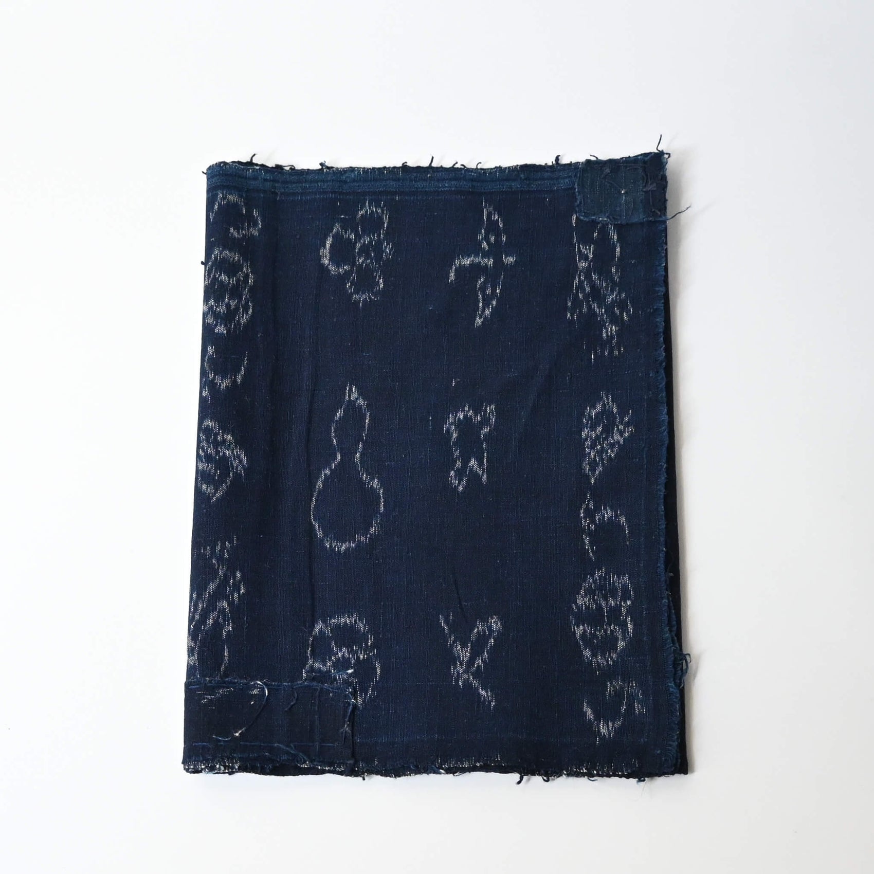 Rare vintage indigo kasuri cotton with pictorial motifs,  including gourds, plum blossoms, and umbrellas.