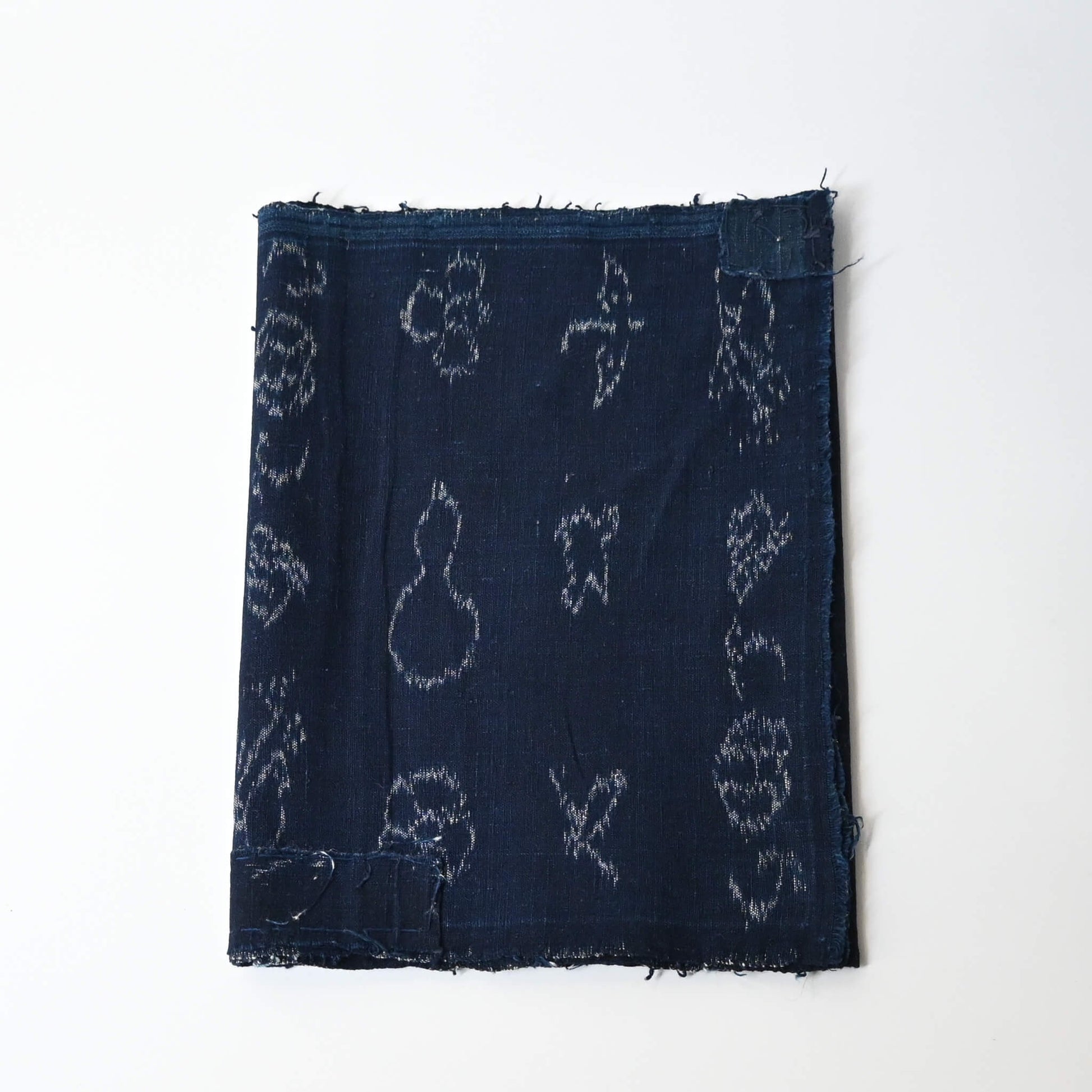 Rare vintage indigo kasuri cotton with pictorial motifs,  including gourds, plum blossoms, and umbrellas.