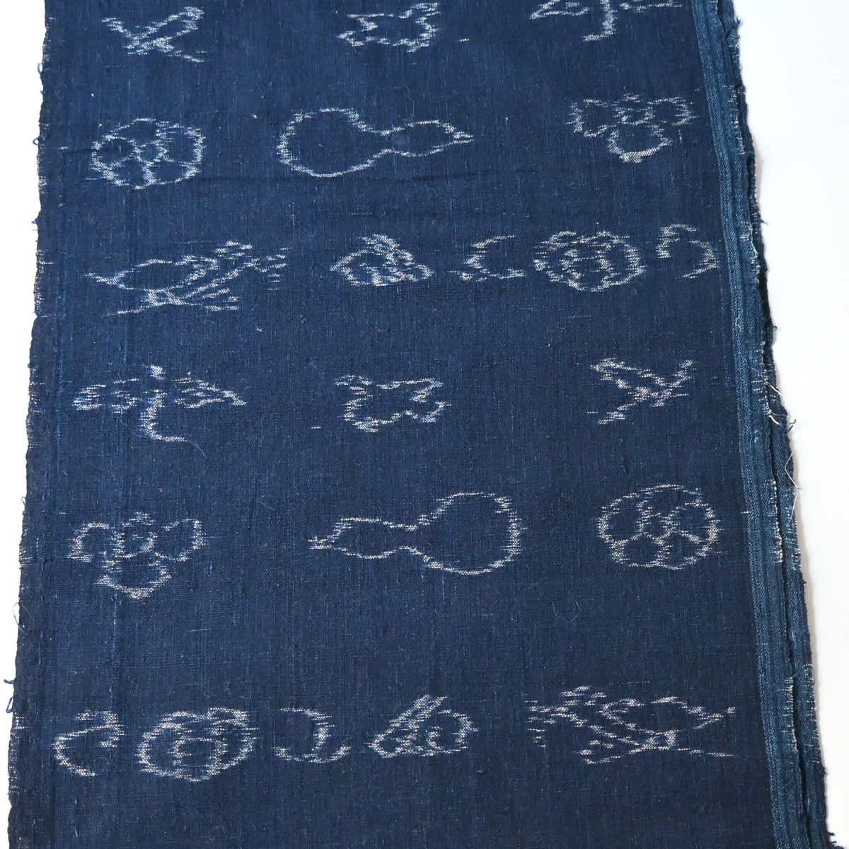 Rare vintage indigo kasuri cotton with pictorial motifs,  including gourds, plum blossoms, and umbrellas.