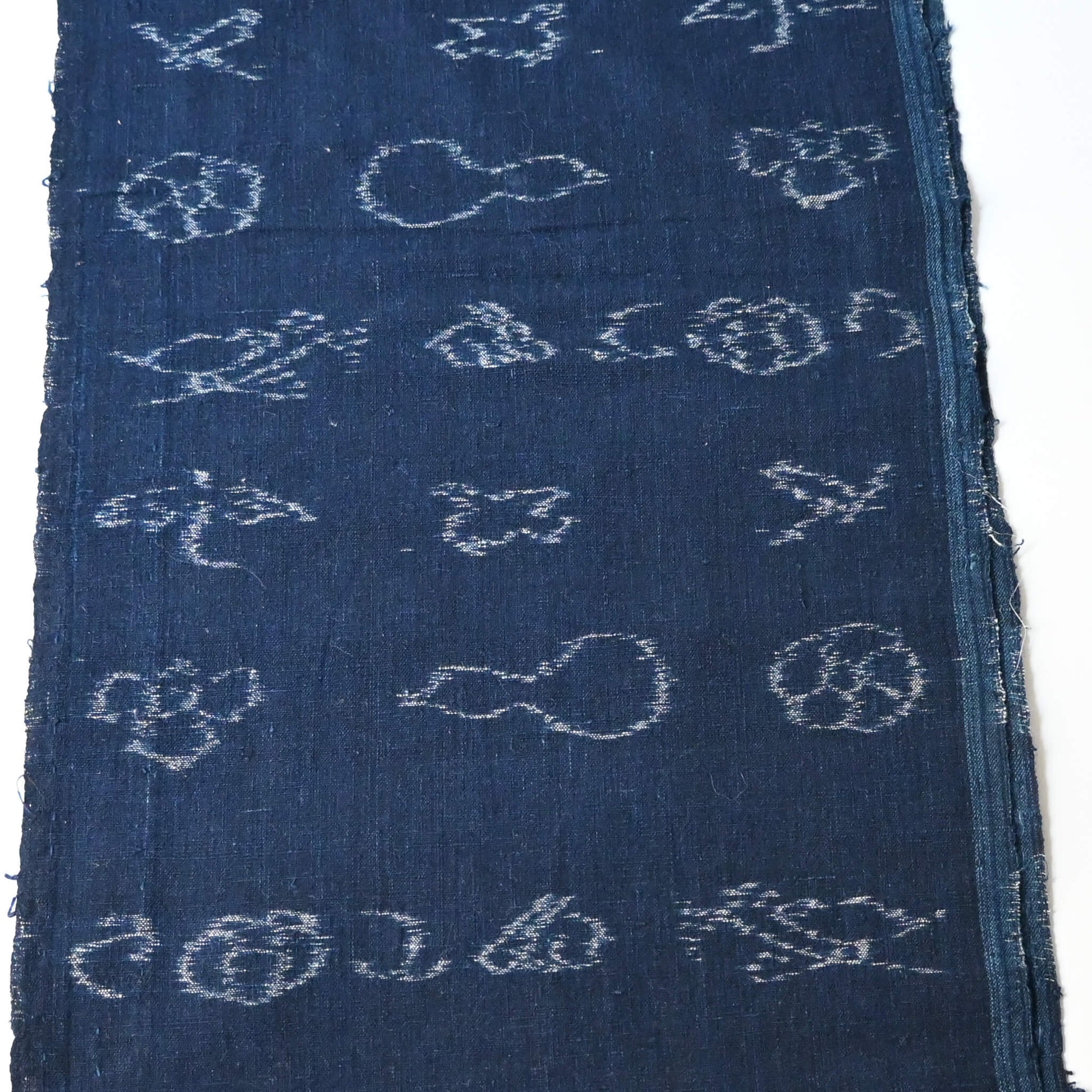 Rare vintage indigo kasuri cotton with pictorial motifs,  including gourds, plum blossoms, and umbrellas.