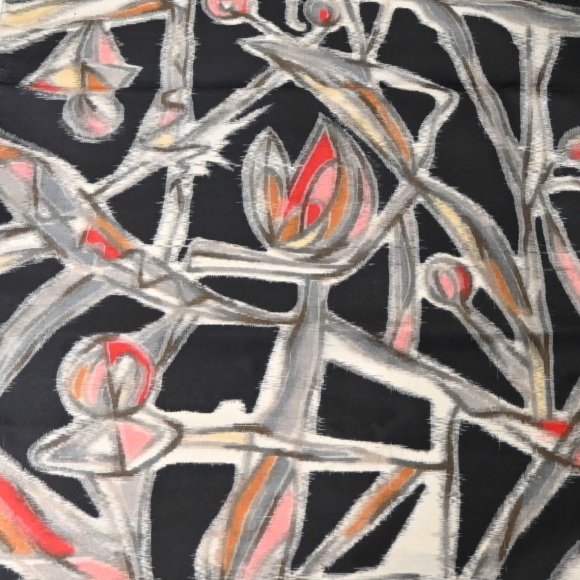 Detailed view of vintage Meisen silk kimono fabric in black with pink and red cubism floral pattern.