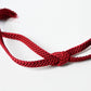 A recycled vintage obijime braided cord in a vibrant red.