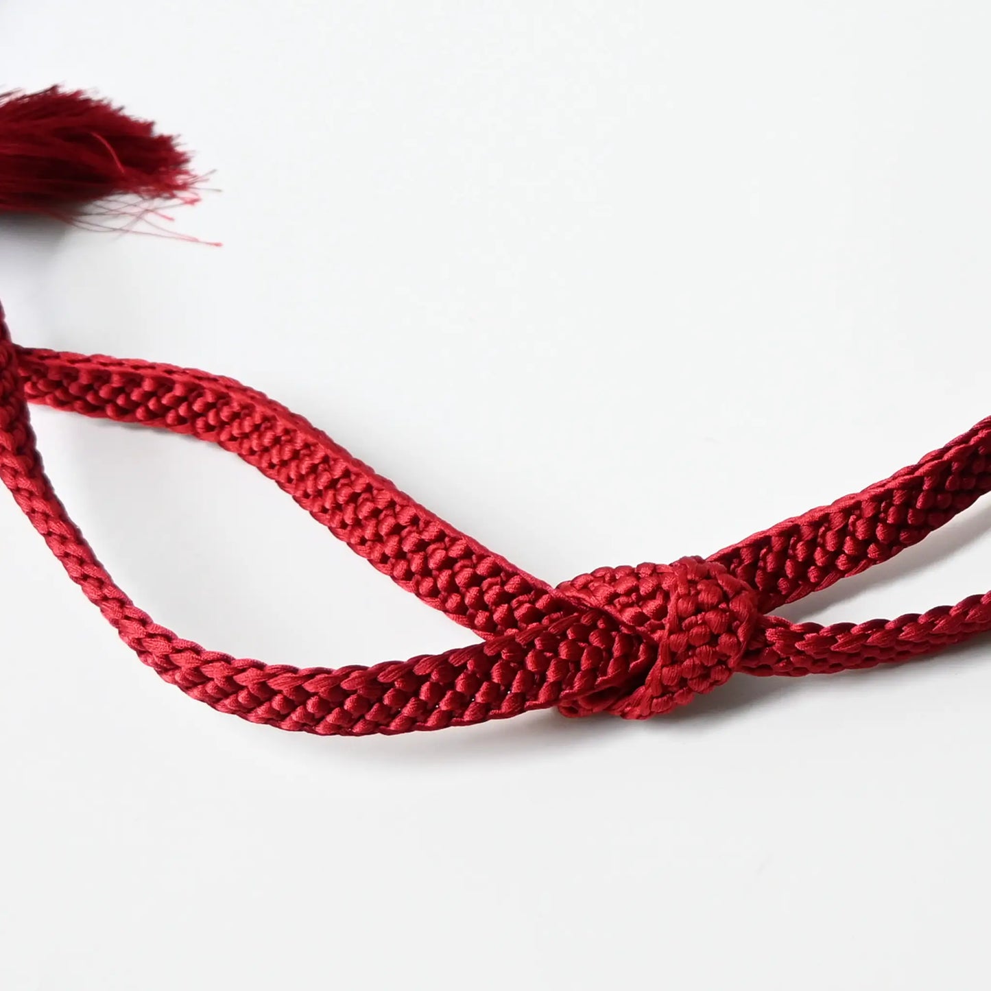 A recycled vintage obijime braided cord in a vibrant red.