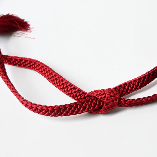 A recycled vintage obijime braided cord in a vibrant red.