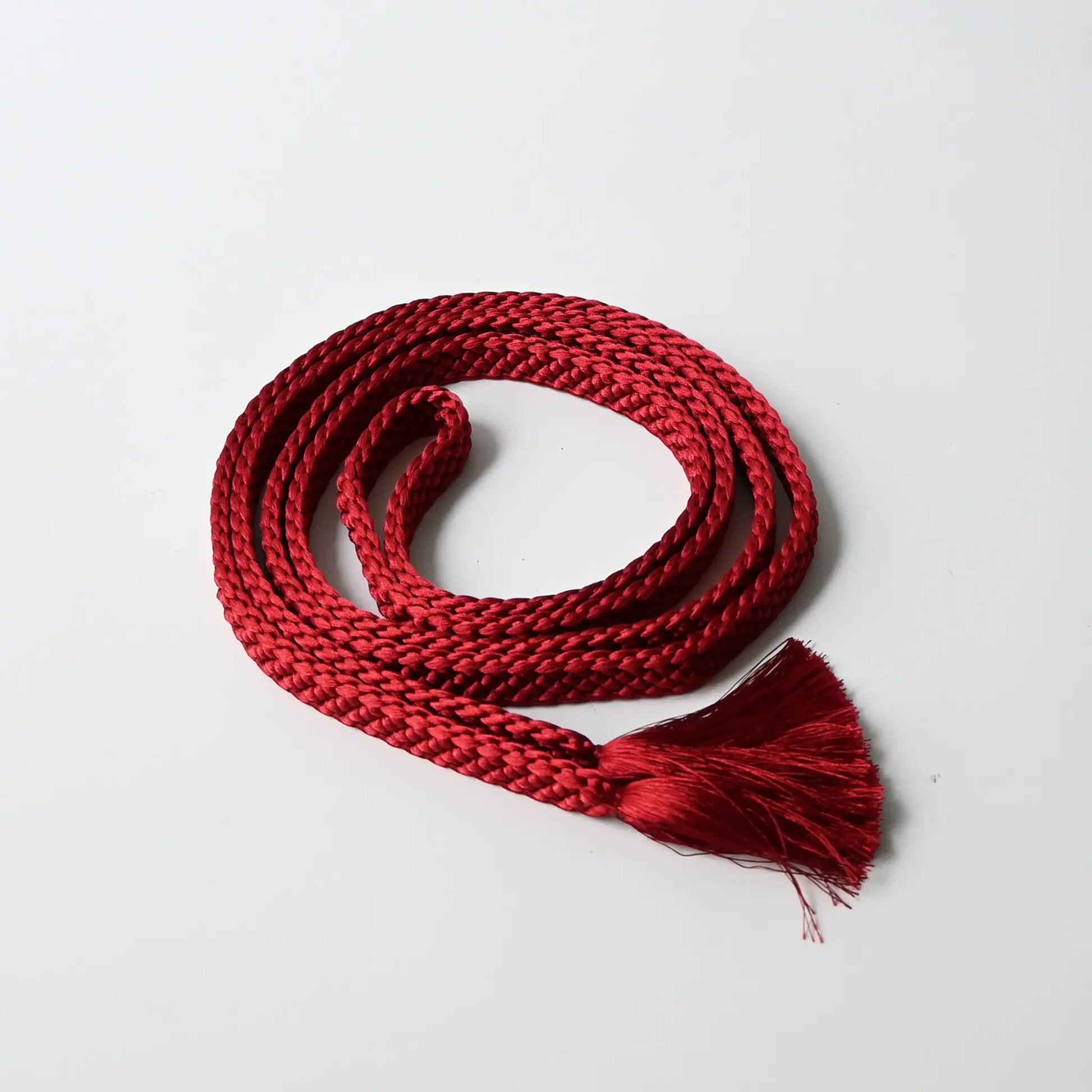 A recycled vintage obijime braided cord in a vibrant red.