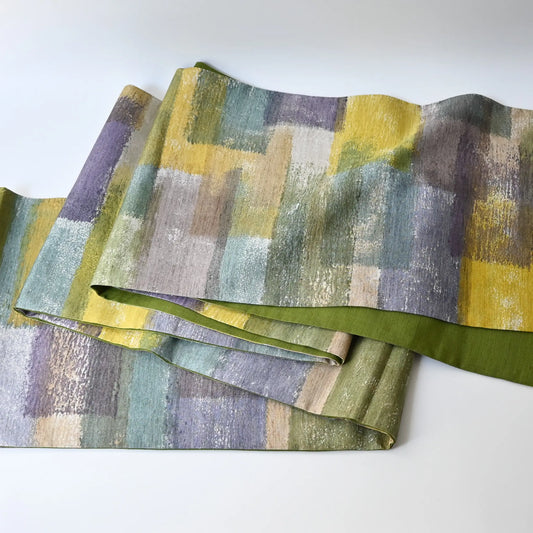 Full view of recycled women's tsumugi silk obi with dyed abstract painterly motif.