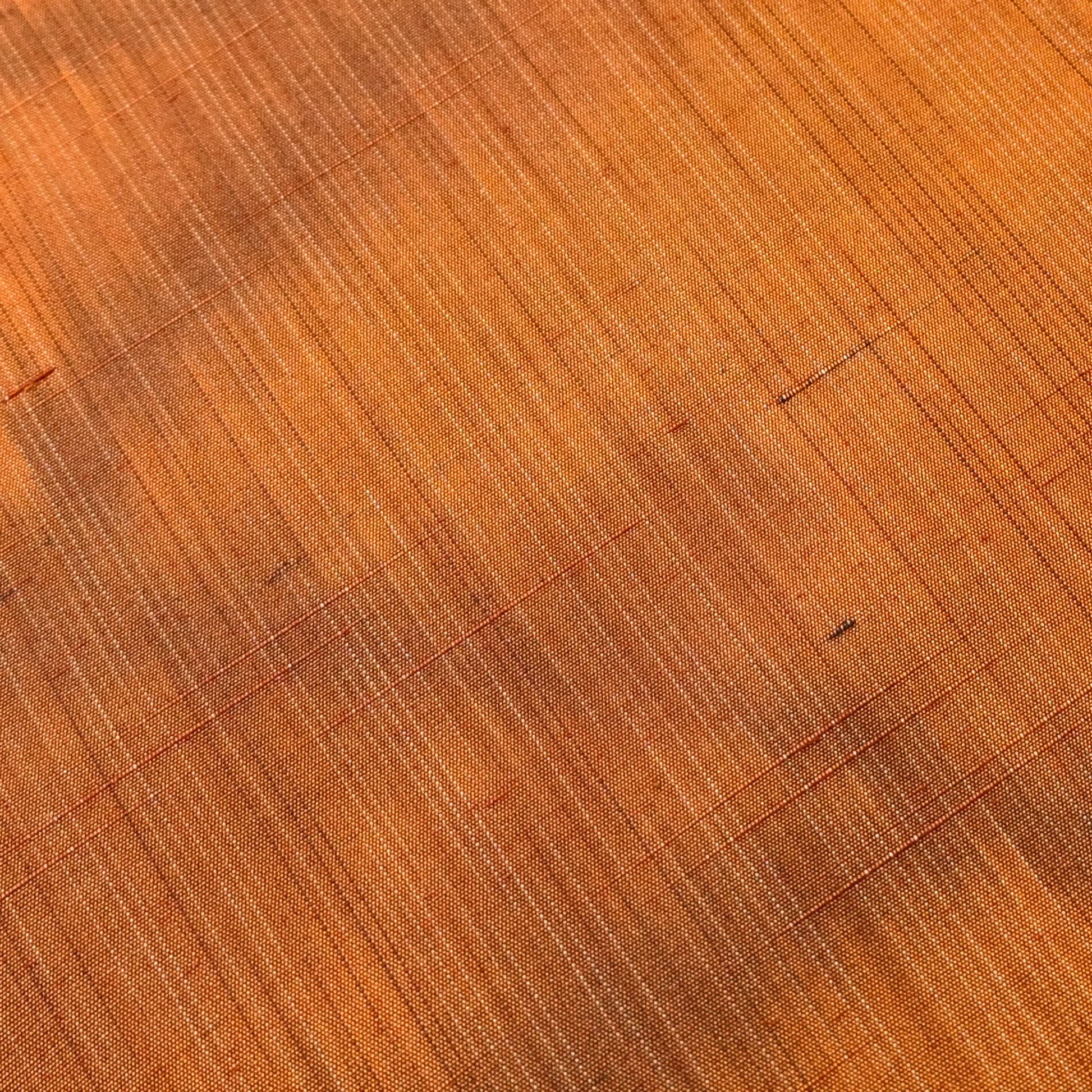 Detailed view of vintage amber brown tsumugi silk kimono fabric with abstract pattern, sold by the metre.