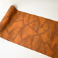 Full view of vintage amber brown tsumugi silk kimono fabric with abstract pattern, sold by the metre.
