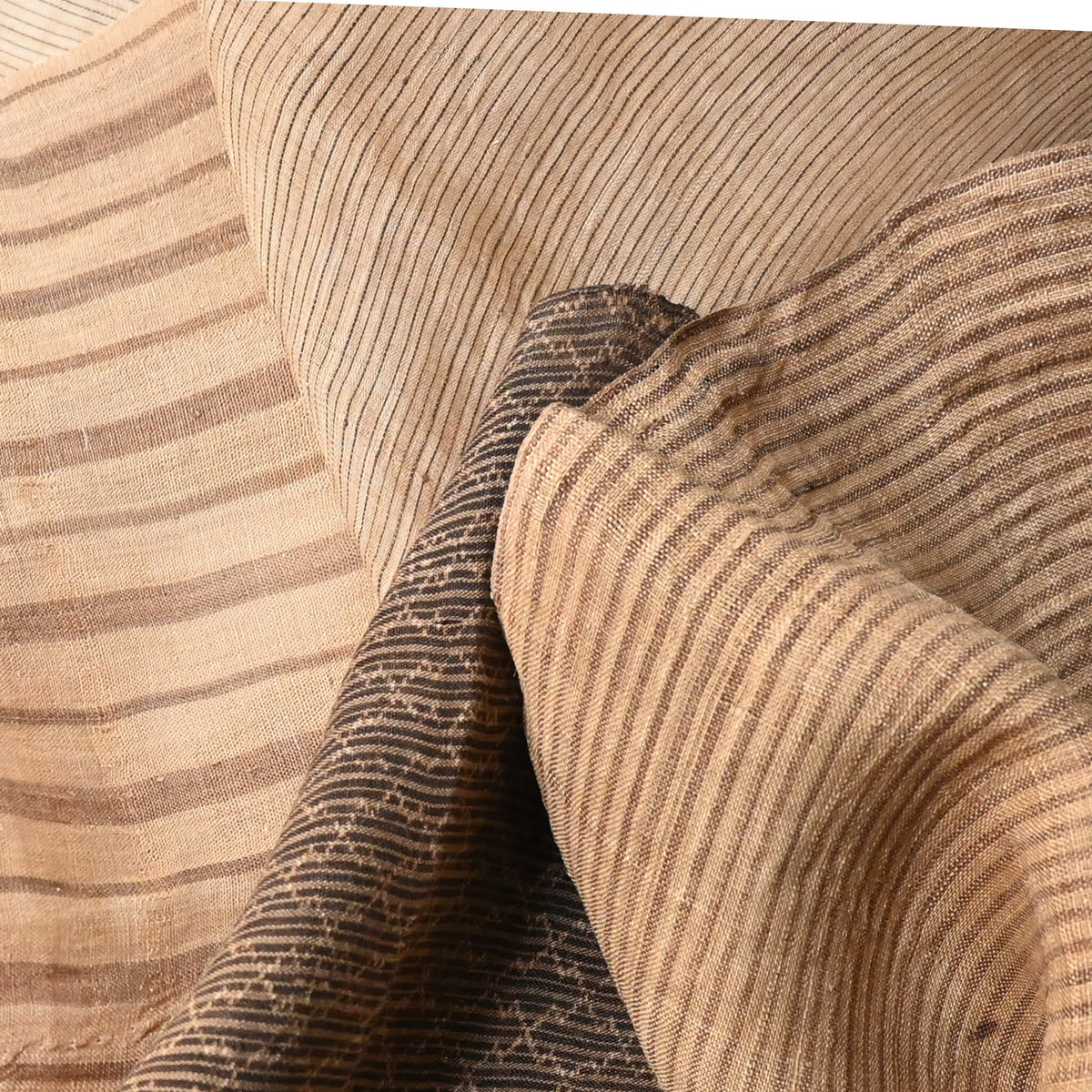 Close-up view of assorted four vintage collectable bashofu banana fibre textile pieces, from Okinawa Japan.