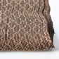 Close-up view of vintage collectable bashofu banana fibre textile fragment in rich brown with geometric pattern.