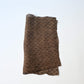 Vintage collectable bashofu banana fibre textile fragment in rich brown with geometric pattern.