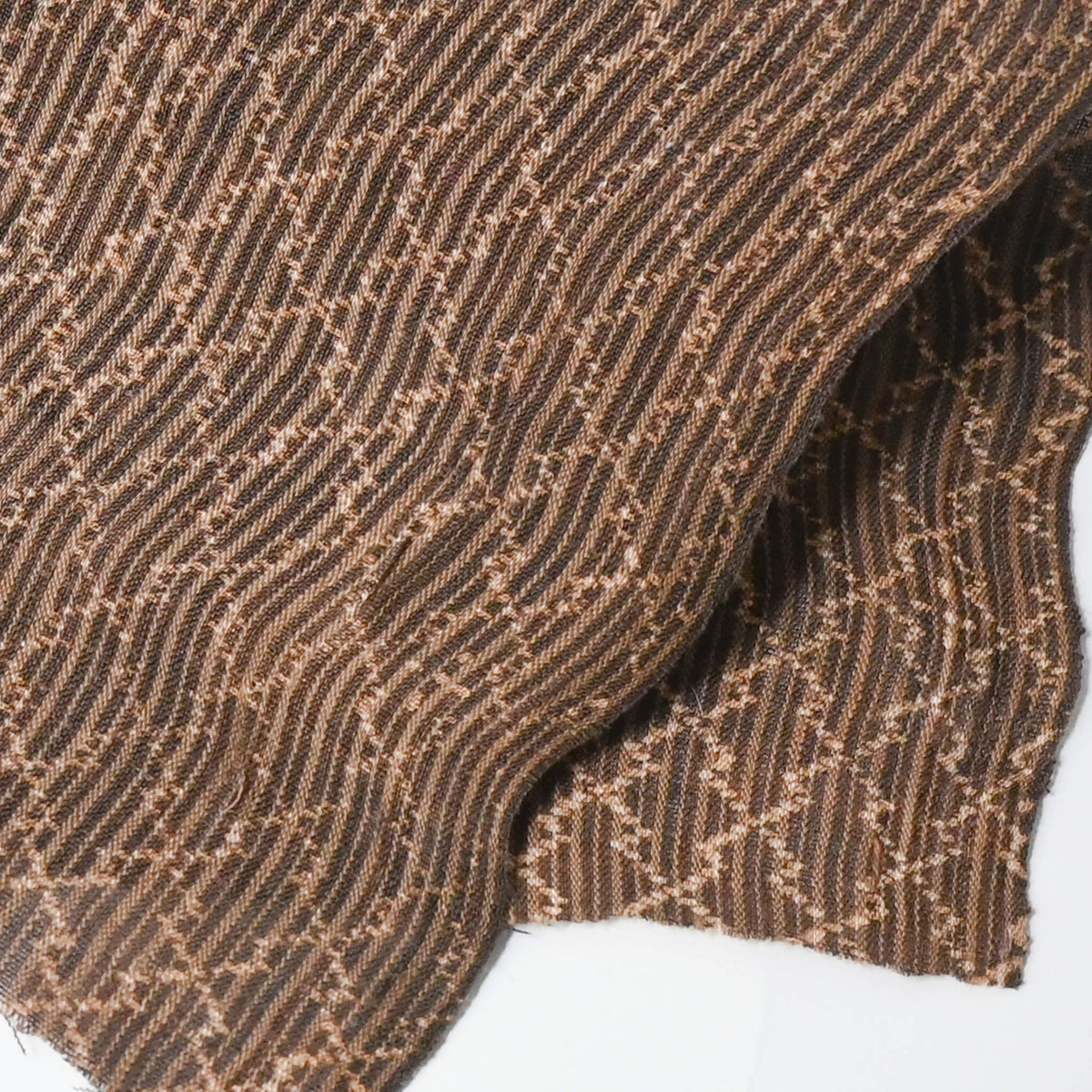 Close-up view of vintage collectable bashofu banana fibre textile fragment in rich brown with geometric pattern.