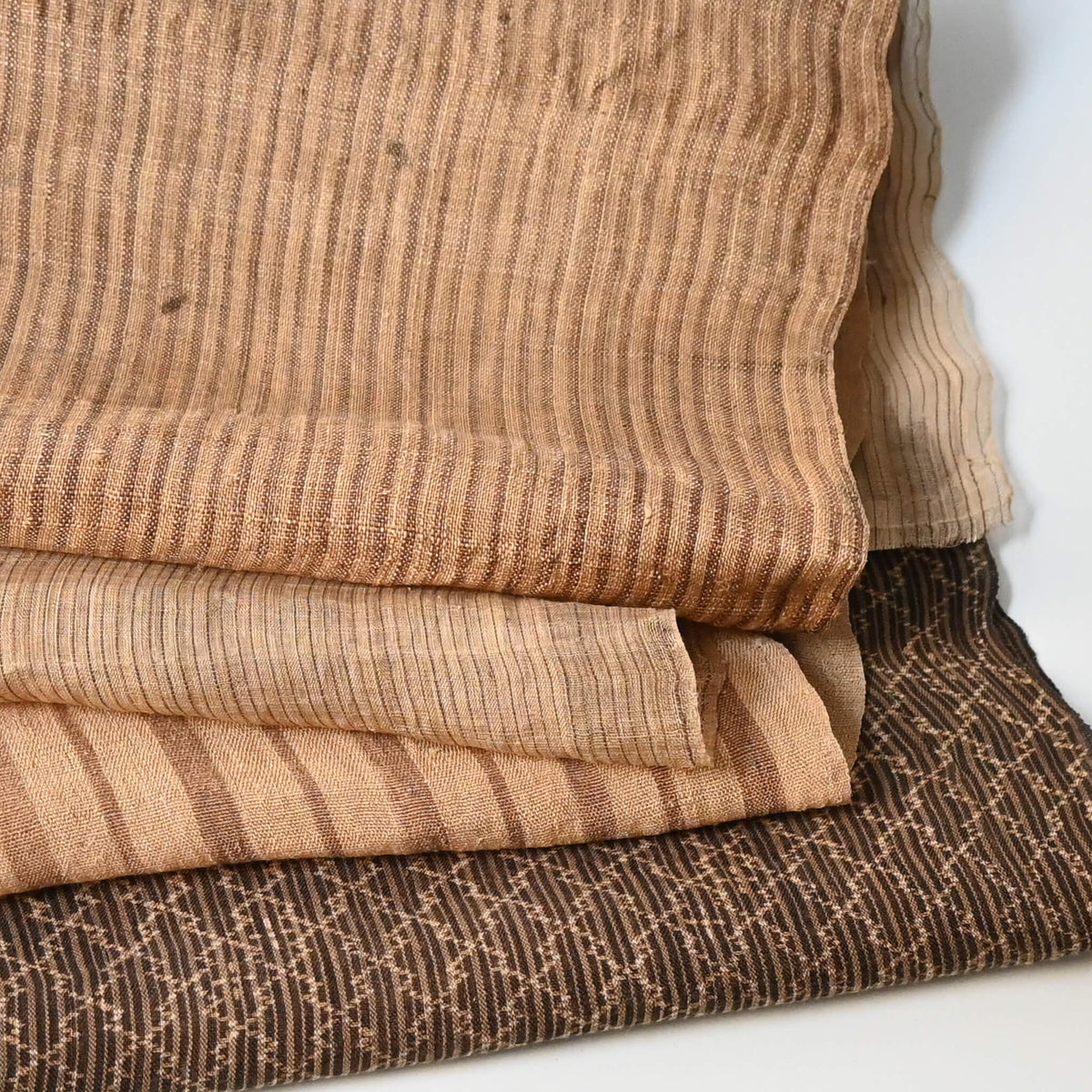Close-up view of assorted four vintage collectable bashofu banana fibre textile pieces, from Okinawa Japan.