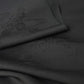 Close-up view of vintage black silk jacquard kimono fabric with running water and chrysanthemum motifs, drape well.