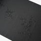 Detailed view of vintage black silk jacquard kimono fabric with running water and chrysanthemum motifs, drape well.
