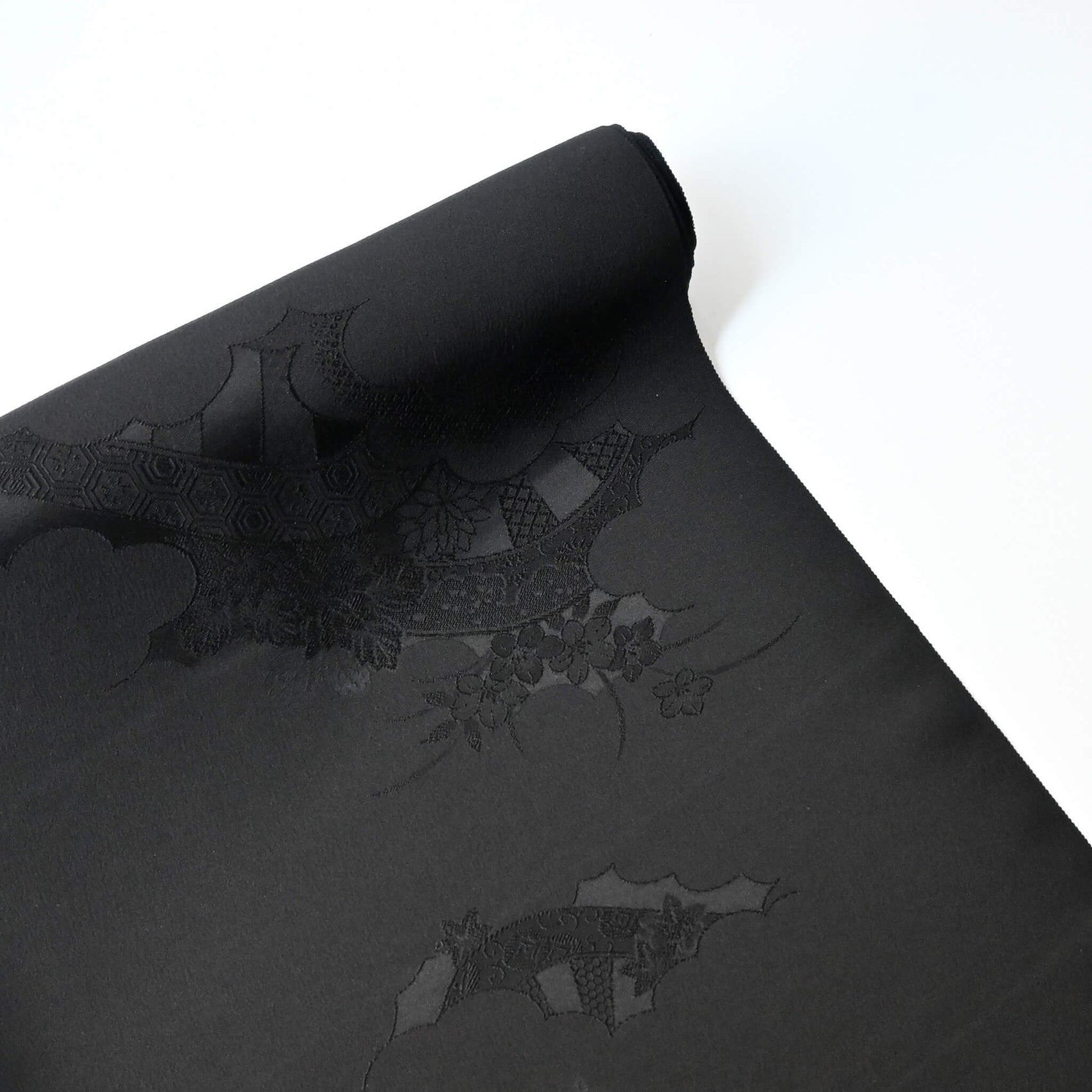 Vintage Japanese black silk jacquard kimono fabric with floral motif, has a soft handle and drapes well.