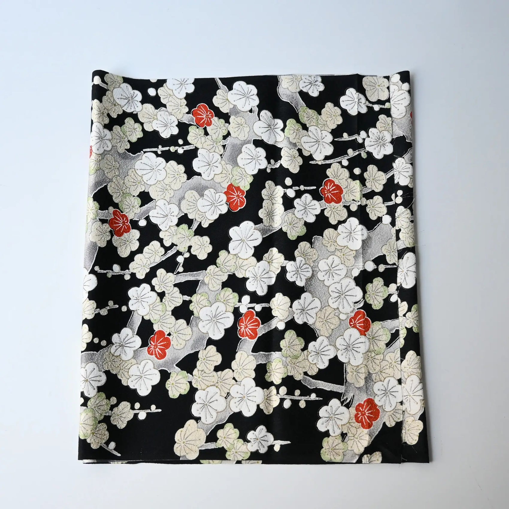 Vintage women's silk kimono fabric piece in black with plum blossom design.