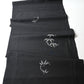 Full view of vintage Japanese tsumugi silk kimono fabric piece in black with small grey bamboo motif.