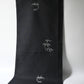 Hanging view of vintage Japanese tsumugi silk kimono fabric piece in black with small grey bamboo motif.