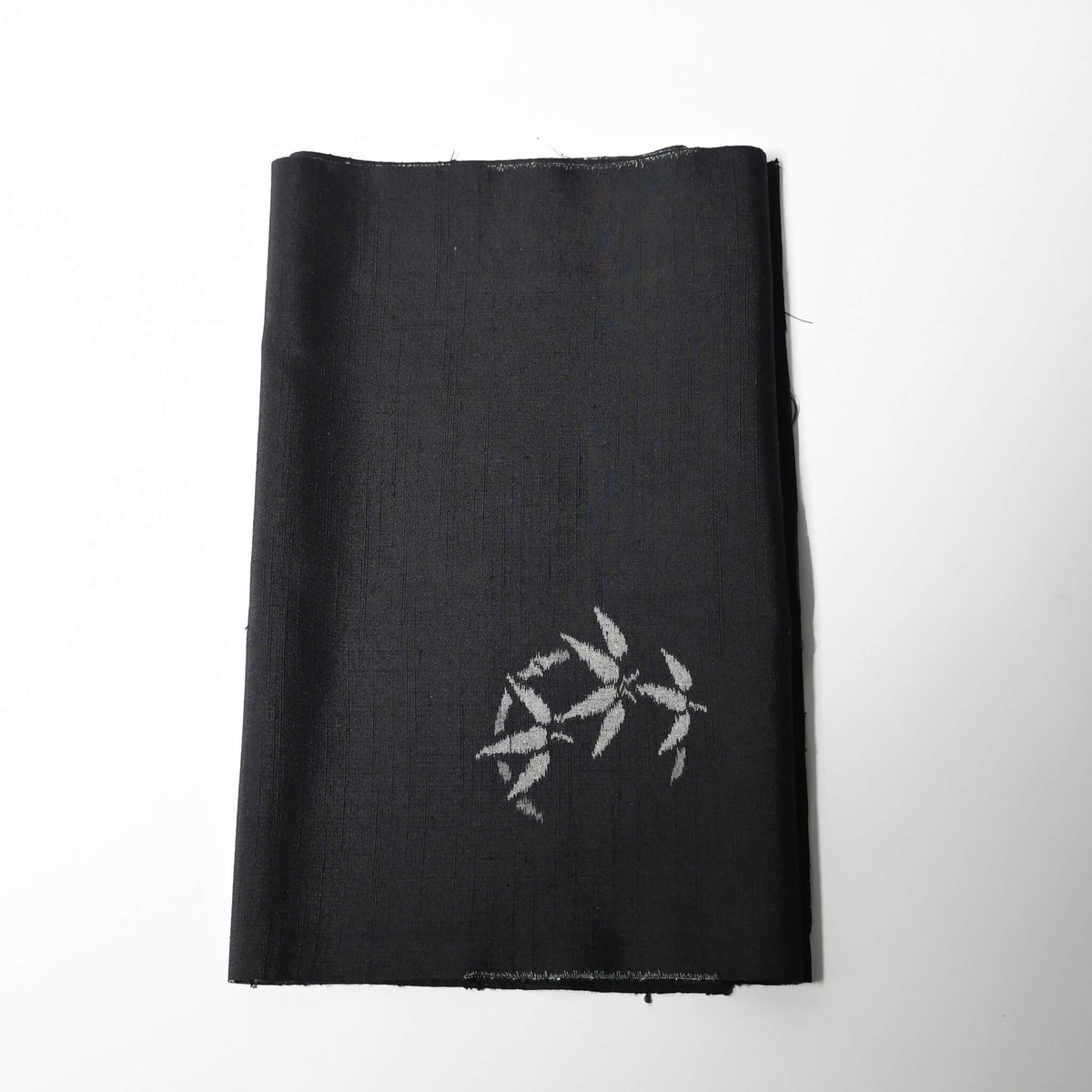 Vintage Japanese tsumugi silk kimono fabric piece in black with small grey bamboo motif.