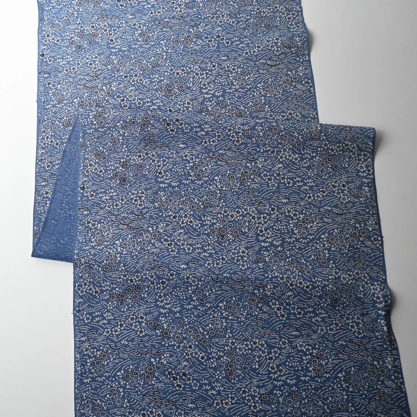 Full view of vintage blue heavy silk crepe kimono fabric with katazome dyed small floral pattern.