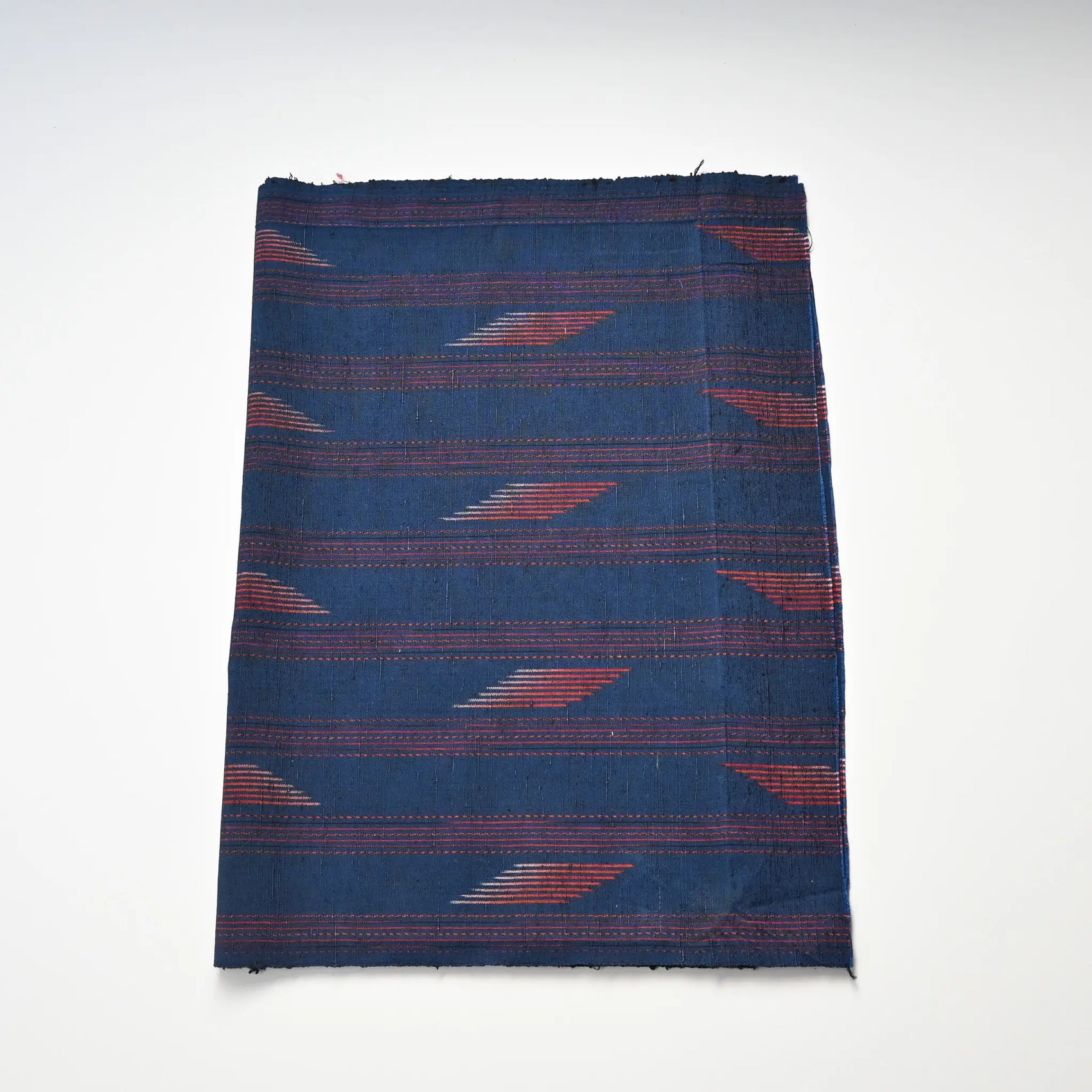 Vintage Japanese blue tsumugi silk kimono fabric piece with red line pattern.