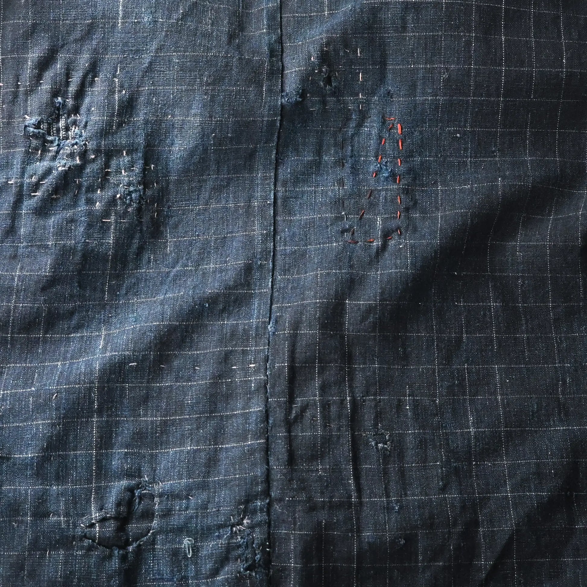 Detailed view of vintage Japanese Boro indigo cotton Noragi from the early to mid-20th century.