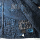 Detailed view of vintage Japanese Boro indigo cotton Noragi from the early to mid-20th century.