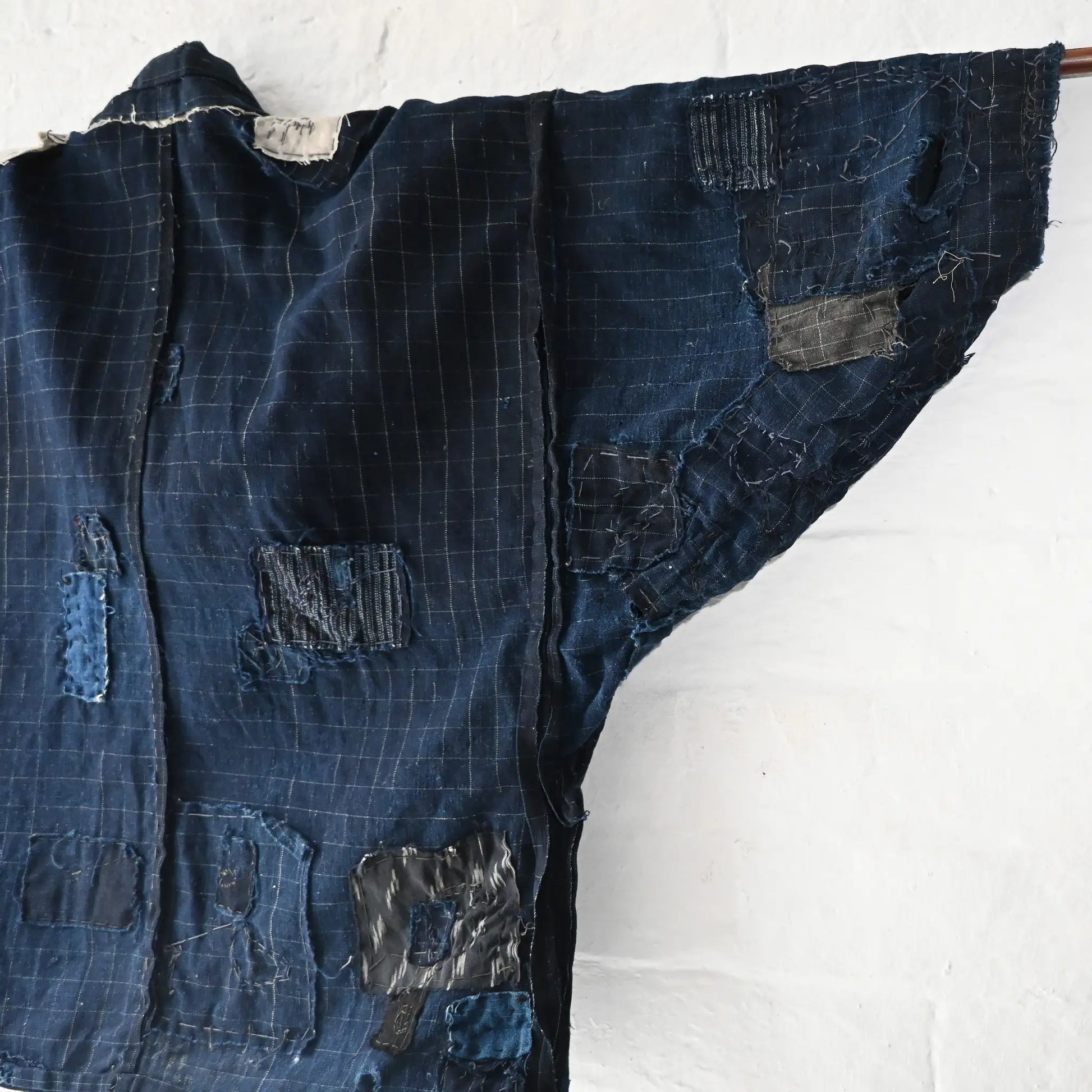 Detailed view of vintage Japanese Boro indigo cotton Noragi from the early to mid-20th century.