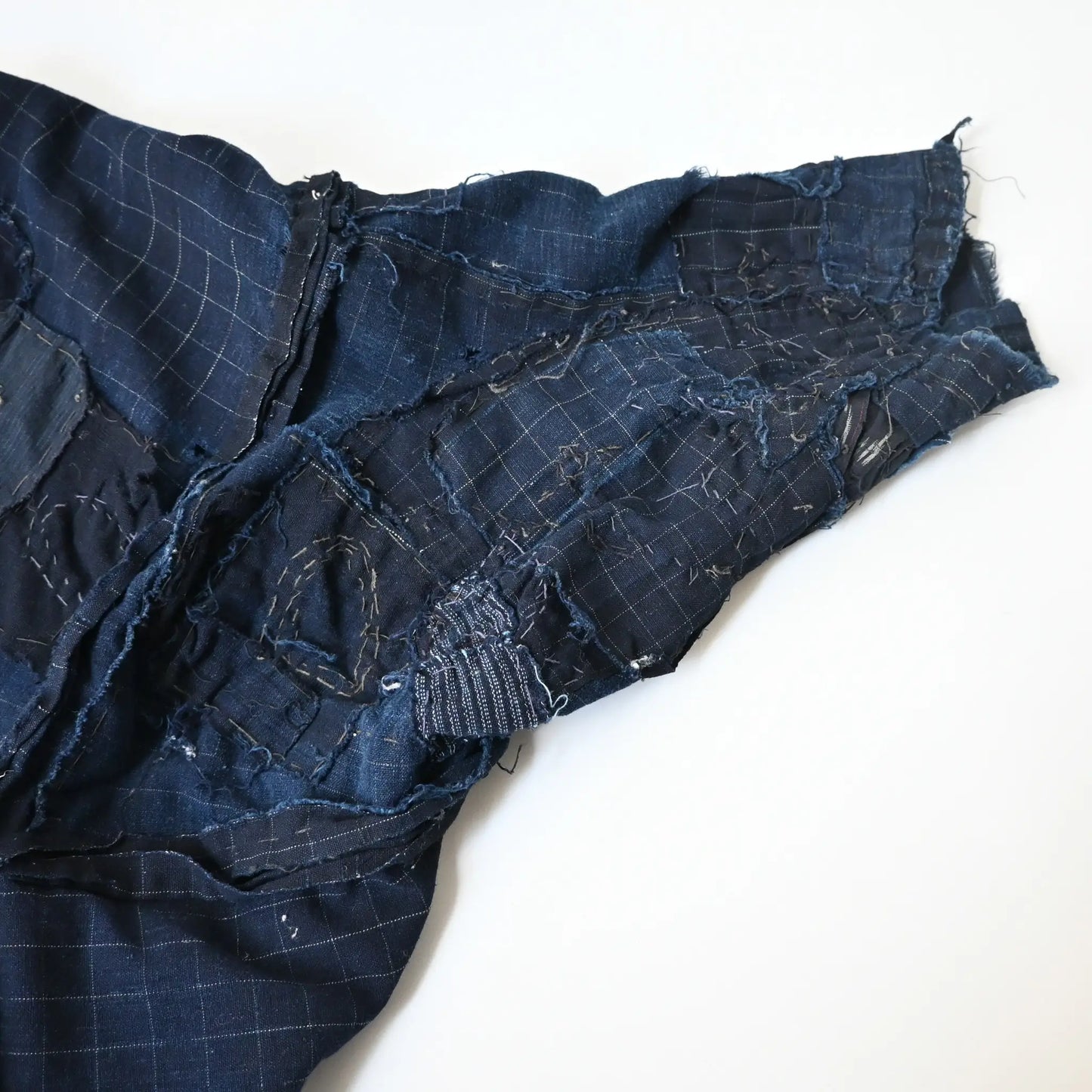 Detailed view of vintage Japanese Boro indigo cotton Noragi from the early to mid-20th century.