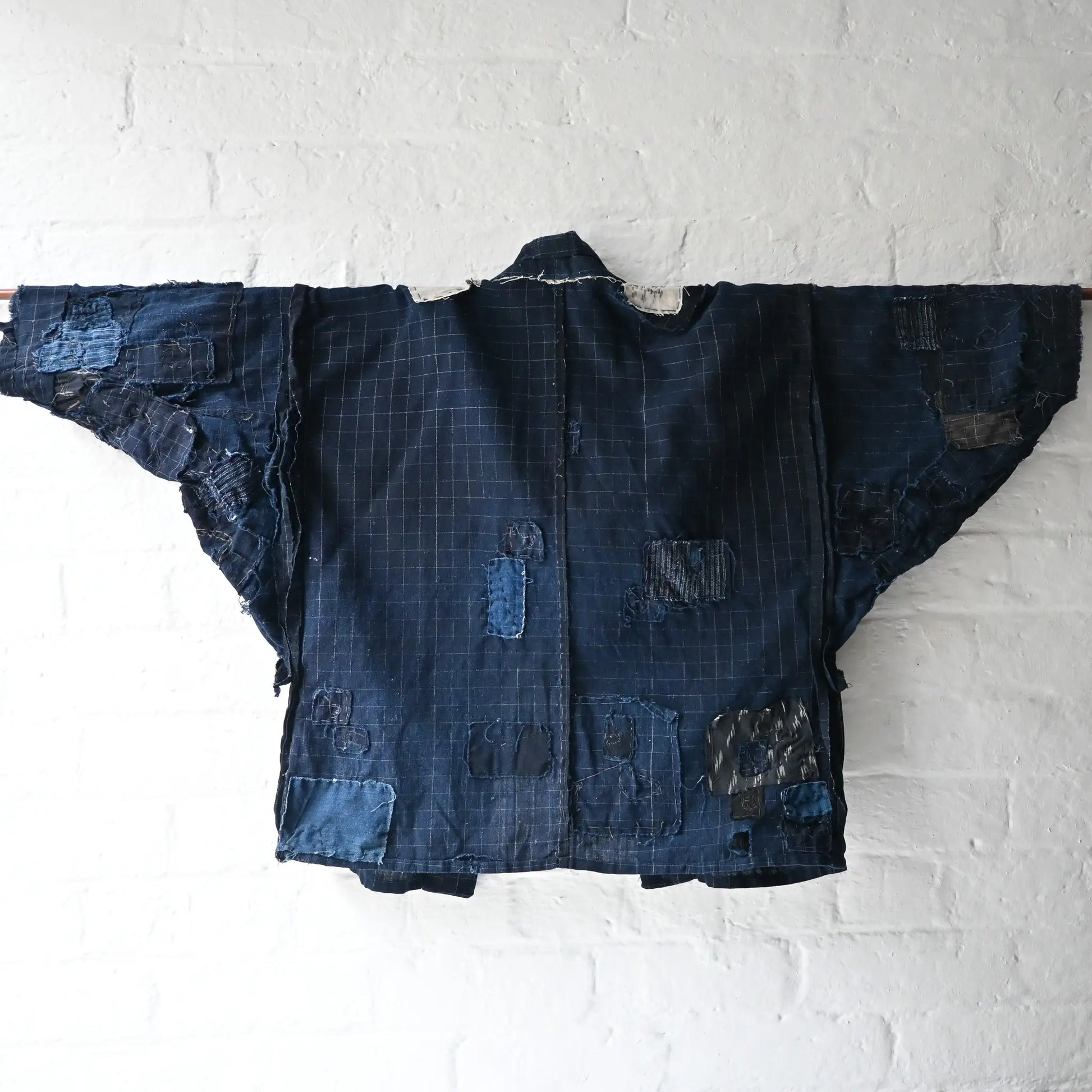Detailed view of vintage Japanese Boro indigo cotton Noragi from the early to mid-20th century.
