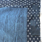 Detailed view of vintage Boro  indigo Kasuri cotton futon cover with patches and stitches.