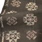 Detailed view of vintage Japanese silk kimono fabric in rich dark brown with kasuri woven pattern.