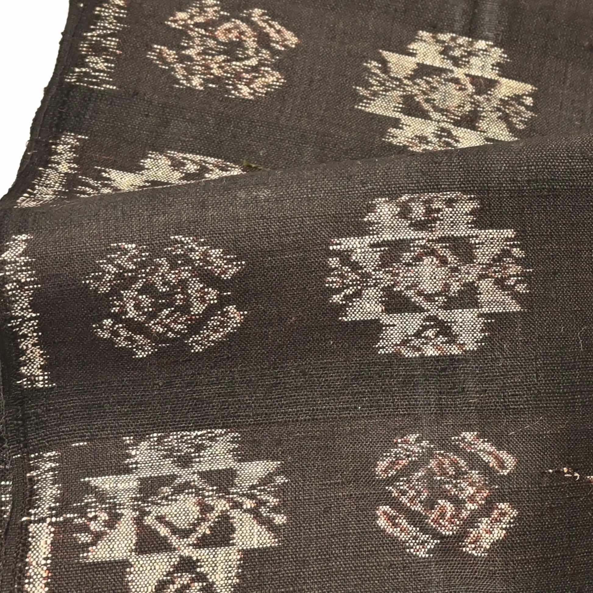 Detailed view of vintage Japanese silk kimono fabric in rich dark brown with kasuri woven pattern.