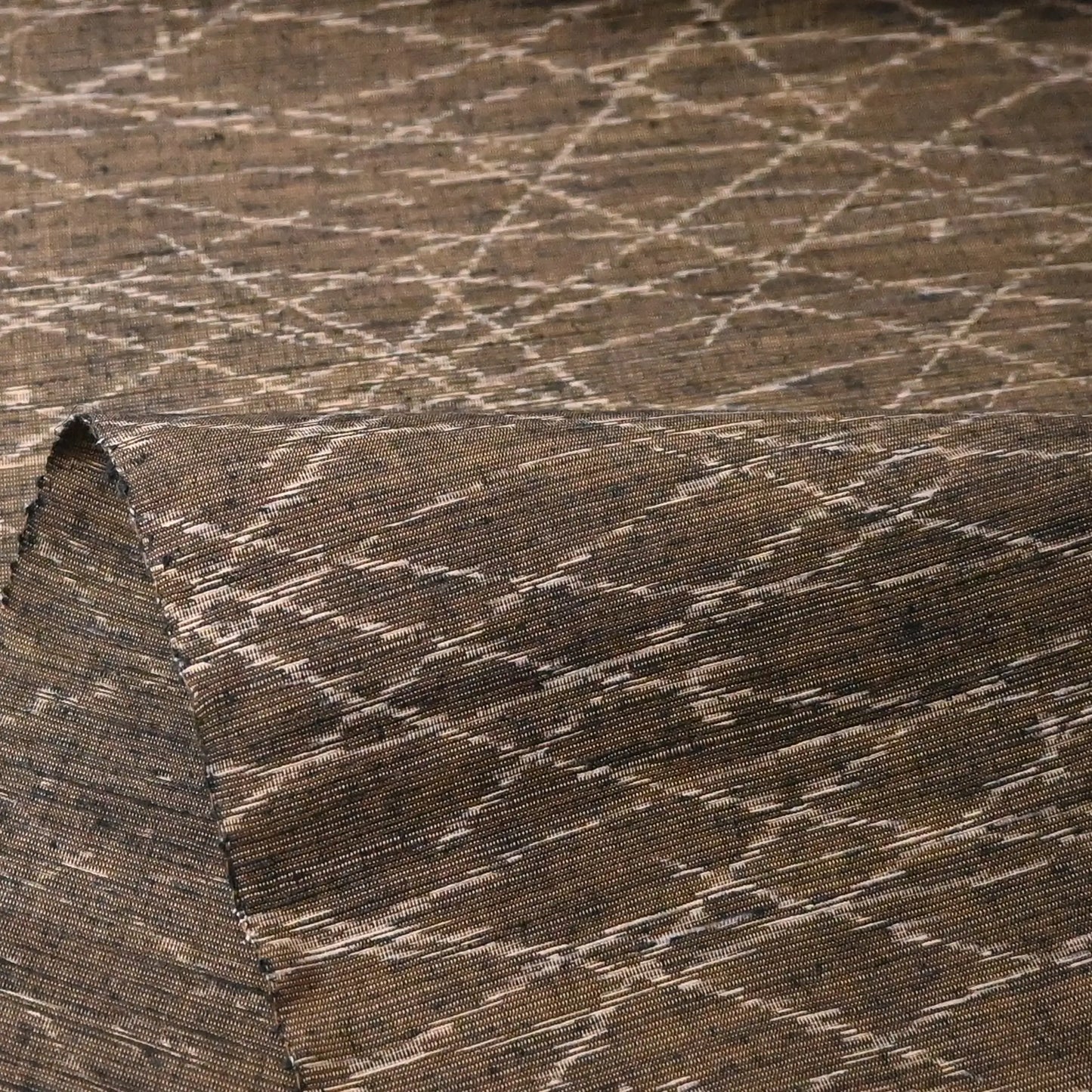 Detailed view of vintage Yuki tsumugi silk kimono fabric in brown and khaki-green tone with autumn grasses motif.