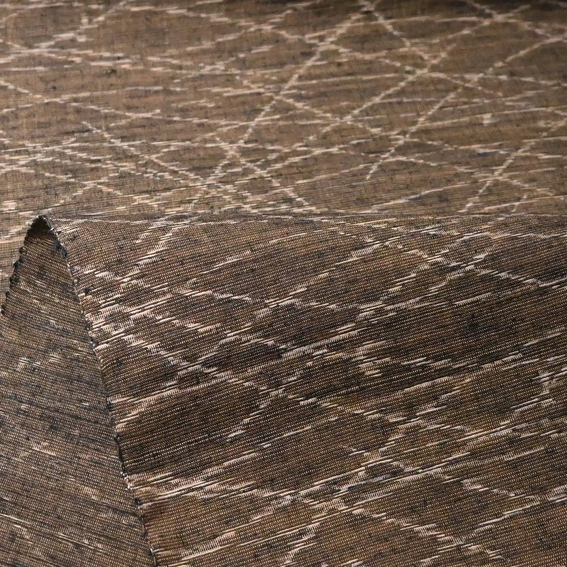 Detailed view of vintage Yuki tsumugi silk kimono fabric in brown and khaki-green tone with autumn grasses motif.