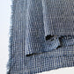 Close-up view of vintage Chinese hand loomed indigo check cotton piece.