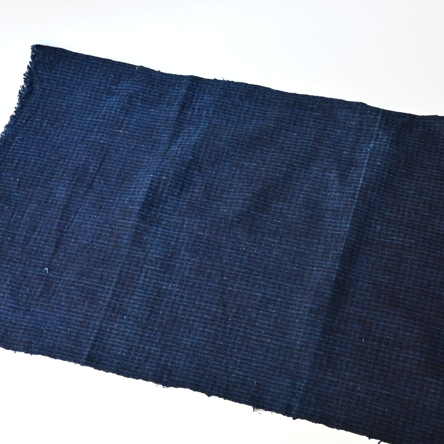 Vintage Chinese indigo check cotton piece with natural texture.