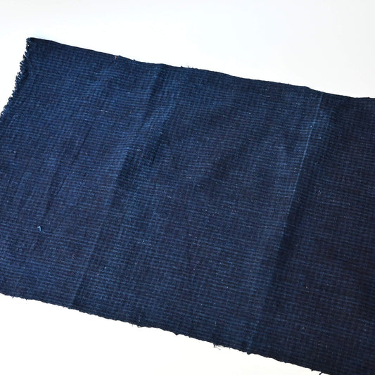 Vintage Chinese indigo check cotton piece with natural texture.