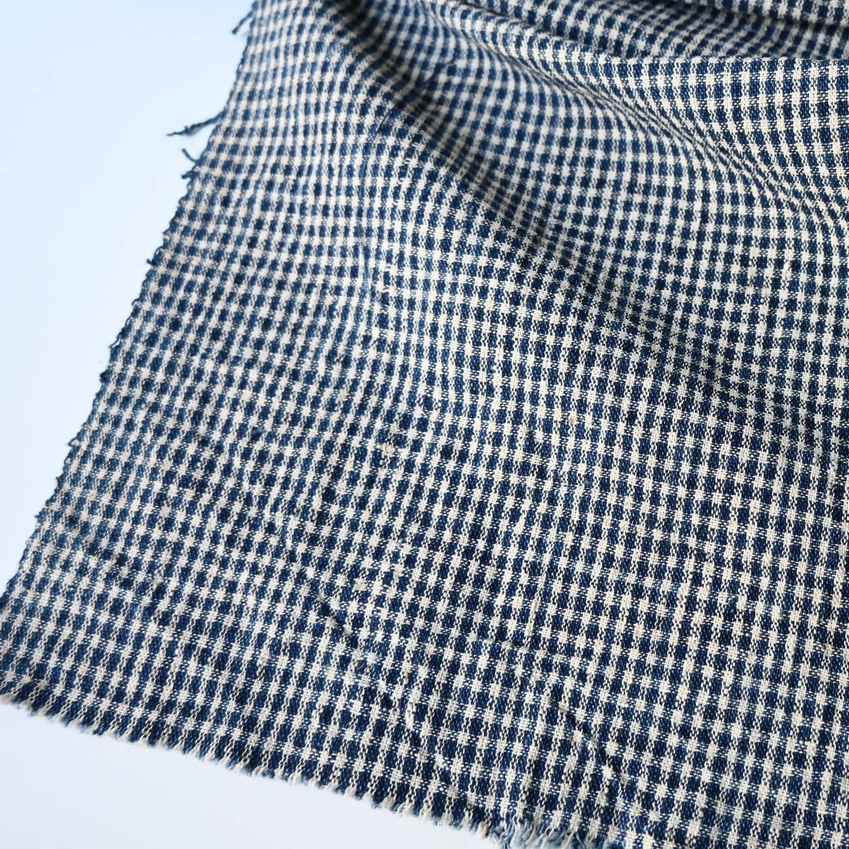 Close-up view of vintage Chinese indigo cotton with small check pattern, suitable for soft furnishings.