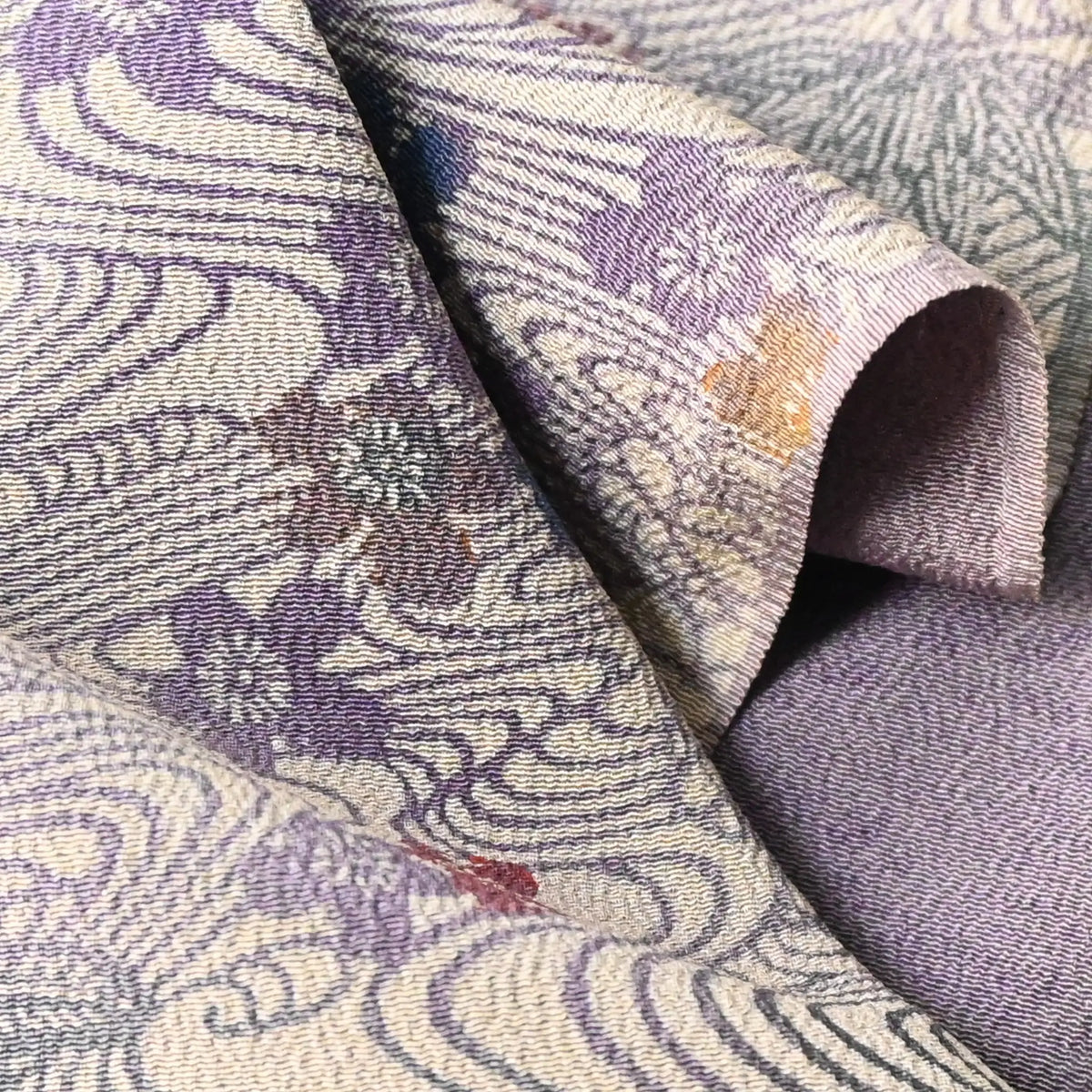 Close-up view of vintage Japanese Chirimen silk crepe kimono fabric piece in muted mauve tones with floral motif.