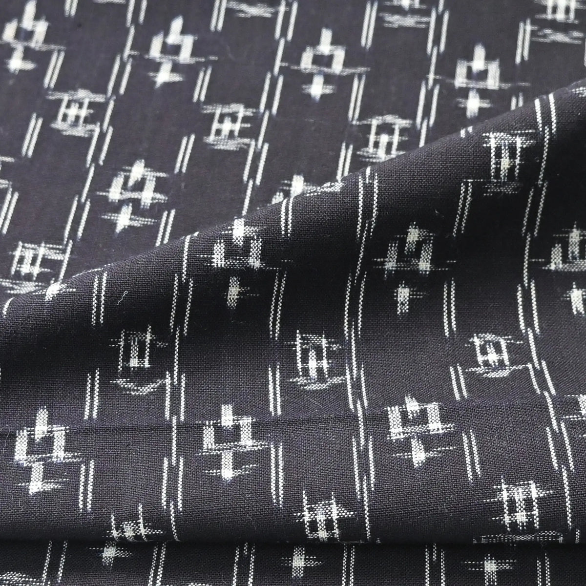 Detailed view of vintage Japanese dark navy kasuri kimono fabric cotton.