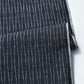 Detailed view of vintage Japanese dark navy Yoroke-jima stripe Tsumugi silk kimono fabric.