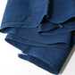 Close-up view of vintage Japanese slightly open weave cotton dyed in deep indigo blue.